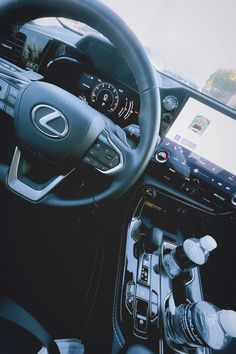 the interior of a car with steering wheel, dashboard and touch screen display on it