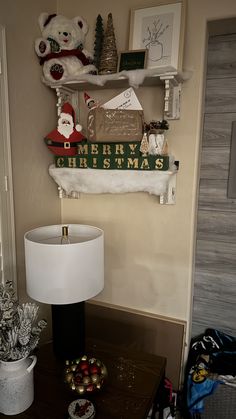 a christmas themed room with teddy bears and other holiday decorations on the wall above it