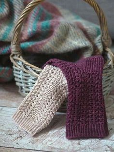 a knitted mitt next to a basket full of blankets