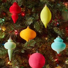 colorful ornaments are hanging from the christmas tree