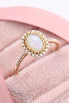 This vintage opal ring is absolutely gorgeous #opalring #vintagering #goldring Opal Wedding Ring Vintage, Opal Pearl Ring, Opal Flower Ring, Opal Ring With Diamonds, Vintage Opal Engagement Rings, Pearl And Opal Engagement Ring, Pearl And Opal Ring, Gold Multi-stone Oval Cabochon Ring, Opal Jewelry With Round Accent Stones