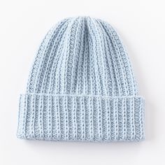 a light blue knitted beanie on a white background