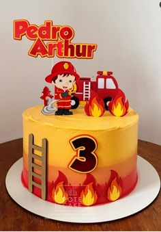 a birthday cake with a fireman on top