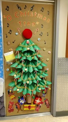 a christmas tree made out of toilet paper and other items on display in front of a door