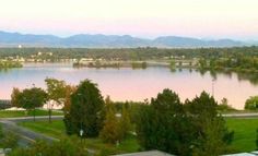 a view of a lake and mountains from the top of a building