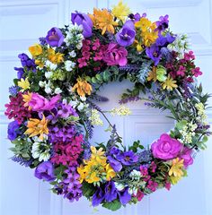 a wreath with purple, yellow and white flowers