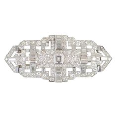 Machine Age Platinum Diamond Brooch
 center emerald cut diamond 1.00ct
 10 carats round diamonds 
 2 carats baguette diamonds Art Deco Diamond Brooch, Bijoux Art Deco, Bijoux Art Nouveau, Art Deco Brooch, Antique Brooches, Diamond Brooch, Deco Jewelry, Art Deco Diamond, Antique Diamond