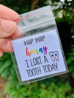 someone is holding up a sticker that says hip hip honeyy i lost a tooth today