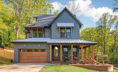 a house with a metal roof and two car garages