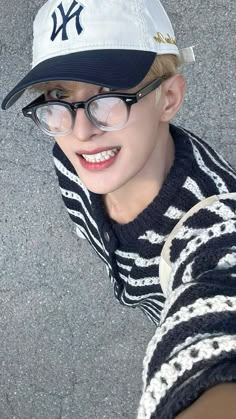 a young boy wearing glasses and a yankees hat