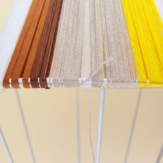 a close up of an umbrella with different colored yarns on the top and bottom