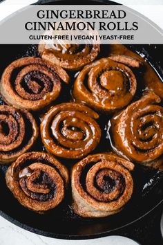 cinnamon rolls in a cast iron skillet with text overlay that reads gingerbread cinnamon rolls gluten - free vegan yeast