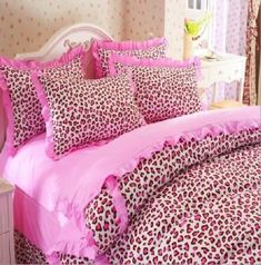 a bed with pink and leopard print sheets