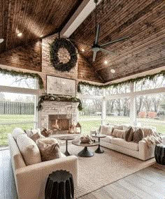 a living room filled with furniture and a fire place in the middle of an open floor plan