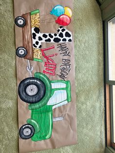 a paper bag with a tractor and balloons on it