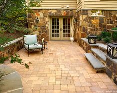 an outdoor patio with stone steps and seating