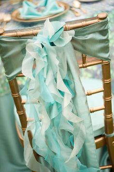 the chair covers are covered with ruffles and ribbons