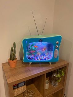 an old tv sitting on top of a wooden shelf