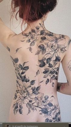 the back of a woman's body with flowers on it