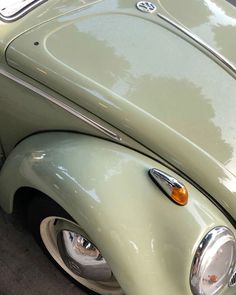 the front end of an old green car