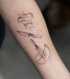 a person with a tattoo on their arm holding a knife and some scissors in it