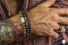 Boho Bracelet set for men made of three unique adjustable matching bracelets that you can buy separately, combine your own set or buy the complete perfect set. The set is composed by: - an ebony wood beaded bracelet with coconut shell beads - an ebony wood beaded bracelet with red Agate heishi beads and African turquoise Jasper gemstones, with stainless steel details - a beautiful bracelet made of frosted tiger eye, african turquoise jasper and red agate gemstones, with coconut shell beads and s Bohemian Hand Wrapped Beaded Bracelets, Pirate Bracelet, Wood Bead Bracelet, Steel Detail, Lucky Bracelet, African Turquoise, Skull Bracelet, Ebony Wood, Stackable Bracelets