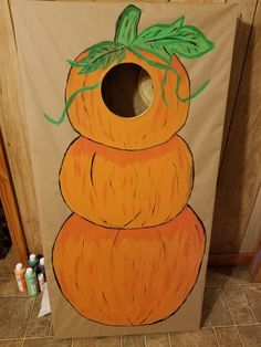 an orange painted pumpkin sitting on top of a cardboard box