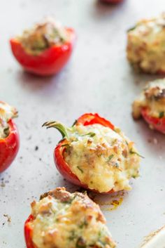 stuffed red peppers on a baking sheet ready to go into the oven