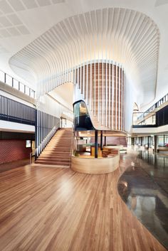 the inside of a building with wooden floors and staircases leading up to an atrium