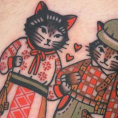 two cats are standing next to each other with hearts in their eyes and one cat is wearing a hat