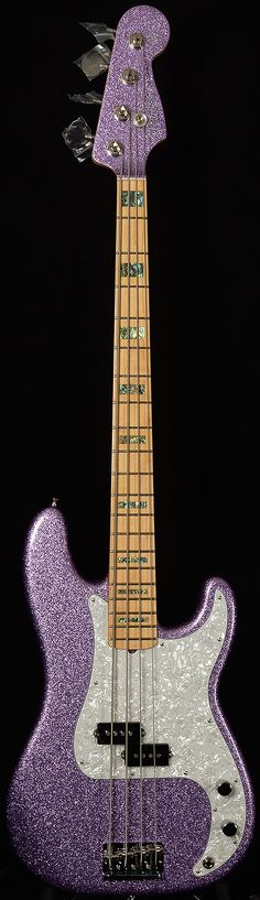 an electric bass guitar with purple glitter on it