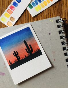 some watercolors are sitting on top of a table