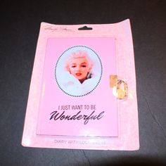 there is a pink card with a picture of marilyn monroe on it that says, i just want to be wonderful