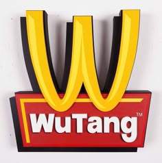 a sign that says wutang on the side of a white wall with black trim