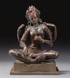 a statue of a woman sitting in the lotus position