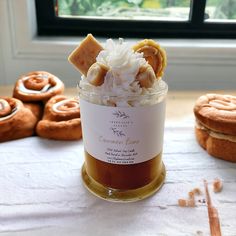 a jar filled with food sitting on top of a table next to some pastries