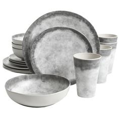 an assortment of gray and white dinnerware