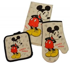 three mickey mouse oven mitts and one pot holder with the same design on it