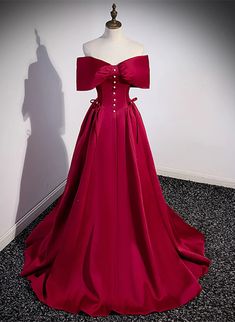 Elegant Burgundy Satin Gown with Off-Shoulder Bow Detail Elegant Fitted Ball Gown With Satin Bow, Elegant Off-shoulder Ball Gown For Formal Events, Elegant Burgundy Ball Gown Evening Dress, Elegant Burgundy Ball Gown For Wedding, Elegant Red Satin Ball Gown, Burgundy Satin Evening Dress For Wedding, Elegant Burgundy Ball Gown For Formal Occasions, Elegant Red Dress With Satin Bow, Off The Shoulder Formal Dress