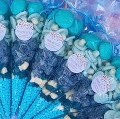 blue and white candies with thank you stickers on them are arranged in a fan shape