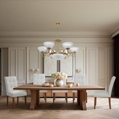 a dining room table with white chairs and a chandelier