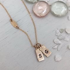 A gorgeous new addition to our collection the Tiny ID Tags Necklace is perfect for the lover of minimalist design. Dainty and sweet. This darling necklace is perfect for everyday wear and makes a lovely gift. Necklace comes with 2 charms, add more to make it uniquely yours. Can be stamped with any initial and also several symbols, pick from heart, moon, stars, cross, pawprint, anchor, compass star. Handmade in our studio of 14kt gold fill or sterling silver for long-term, worry-free wear. Charms