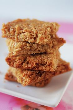 three oatmeal cookies stacked on top of each other on a white plate