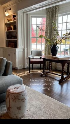 a living room filled with furniture and a large window