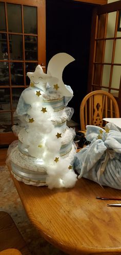 a white christmas tree sitting on top of a wooden table