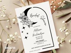 an image of a wedding card with flowers on it and the moon in the background