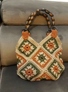 a crocheted purse sitting on top of a couch