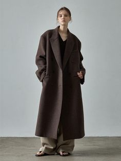 This Cashmere Double Coat is a timeless piece designed for long-term wear without compromising style. It features the classic double-breasted design with comfortable oversized fit.- 6mm shoulder pads for a unique silhouette and cozy fleece-lined pockets- Slit detail at the back for comfortable wear experience- Lined with durable and non-wrinkle fabric 100% Wool Coat, Wool Coat Aesthetic, Korean Style Coat, Winter Coats For Women, Classic Wool Coat, Oversized Brown Coat, Oversized Coat Outfit, Dark Grey Coat, Beige Wool Coat