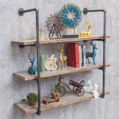 three shelves with books, figurines and other decorative items on them against a gray wall