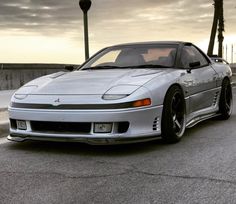 a silver sports car parked on the street